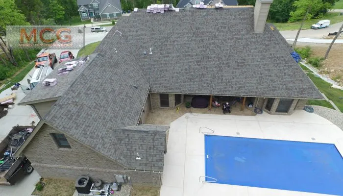 A view of a house from above with the pool in front.