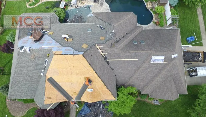 A view of a house from above with the roof being installed.